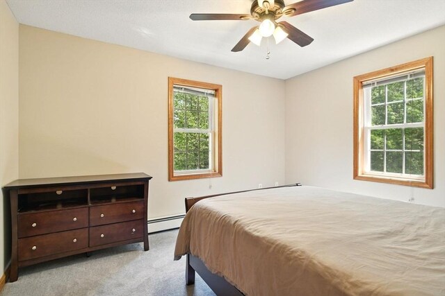 315 Woodland Way, Russell, MA 01071 - bedroom with baseboard heating, light colored carpet, and ceiling fan