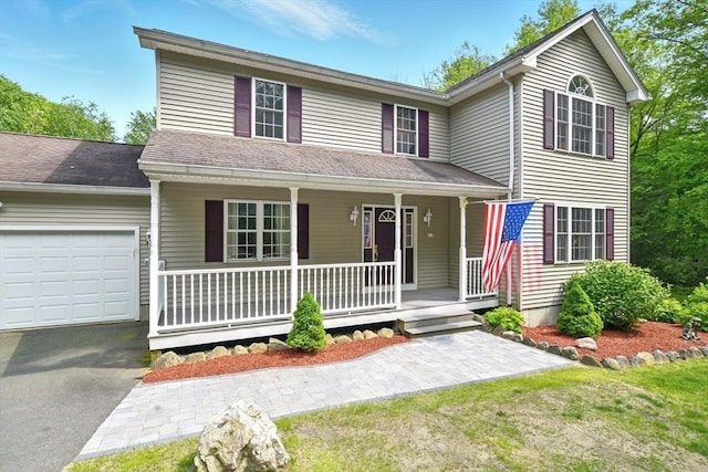 315 Woodland Way, Russell, MA 01071 - traditional-style house featuring a porch, a garage, and driveway