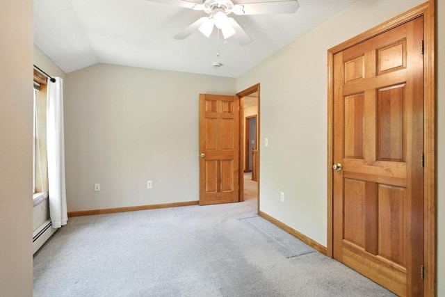 315 Woodland Way, Russell, MA 01071 - unfurnished bedroom with a baseboard heating unit, light carpet, baseboards, vaulted ceiling, and a ceiling fan