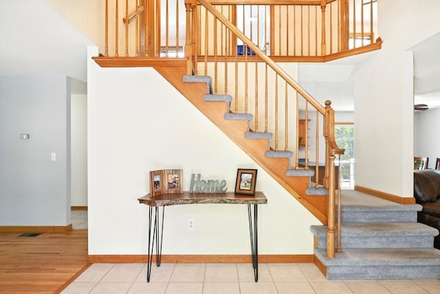 315 Woodland Way, Russell, MA 01071 - stairs featuring baseboards, wood finished floors, and a towering ceiling