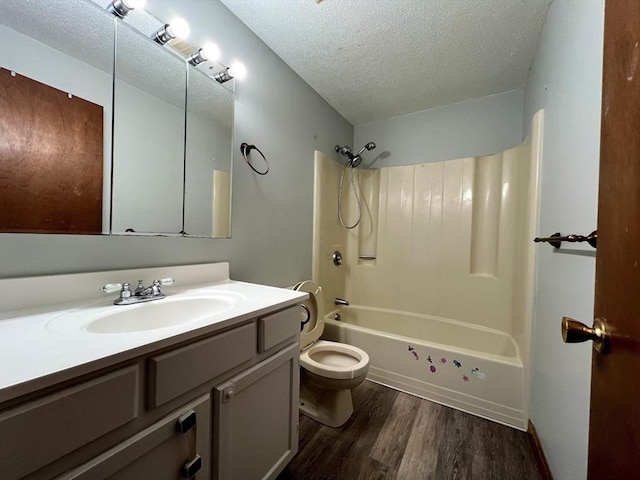 80 Smith St Unit 2A, Lowell, MA 01851 - bathroom featuring wood finished floors, a textured ceiling, toilet, shower / tub combination, and vanity