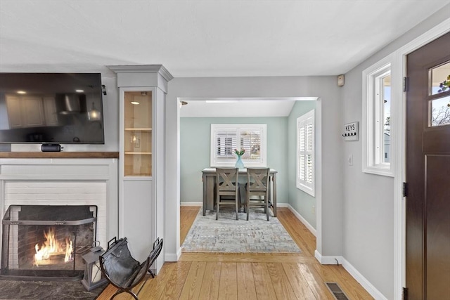 28 Manomet Beach Blvd, Plymouth, MA 02360 - entryway featuring light wood-type flooring, baseboards, and a brick fireplace