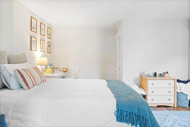 bedroom with dark wood-type flooring