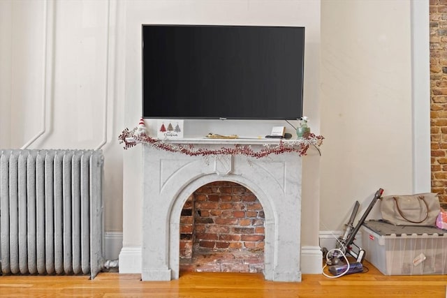 room details featuring radiator and wood-type flooring