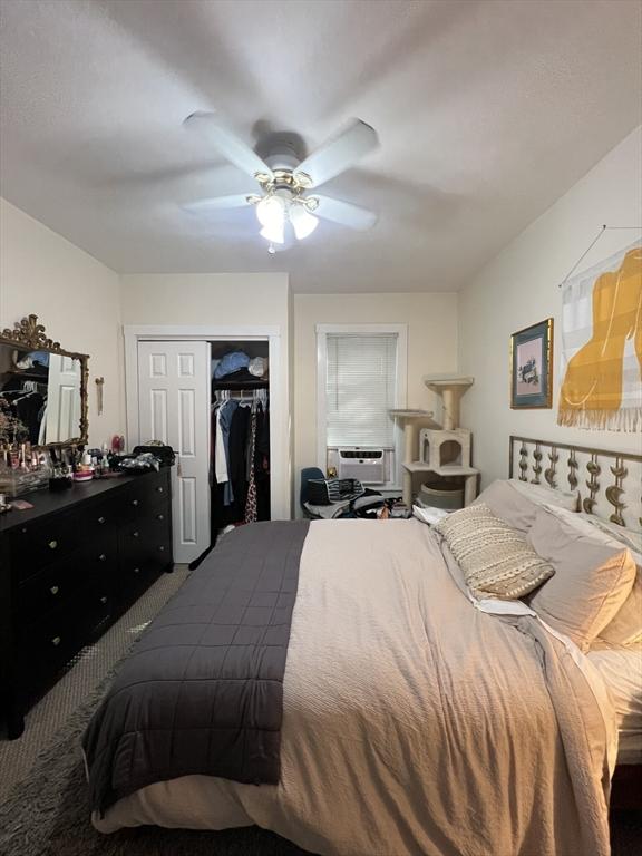 bedroom featuring cooling unit, ceiling fan, carpet floors, and a closet