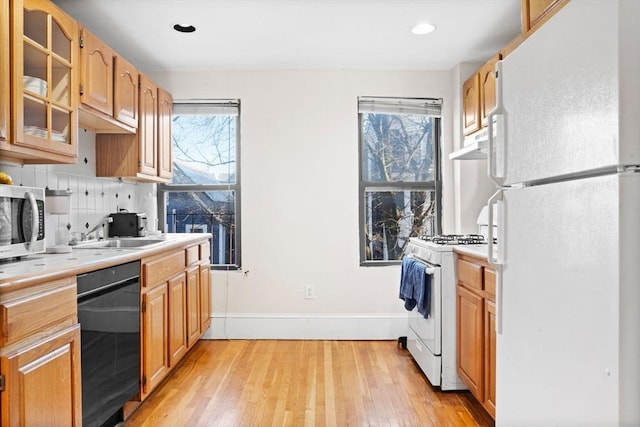 kitchen featuring tasteful backsplash, sink, white appliances, and a wealth of natural light