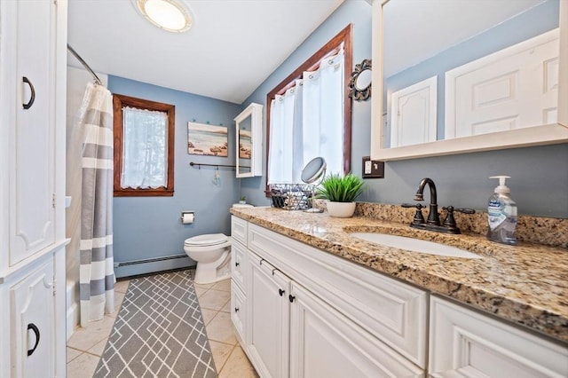 bathroom featuring tile patterned floors, toilet, a baseboard heating unit, and vanity