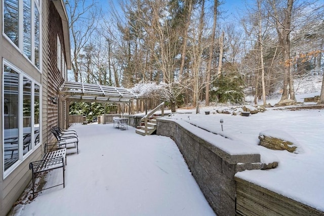 snowy yard with a pergola