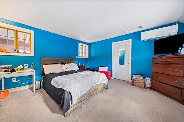 carpeted bedroom with a wall unit AC