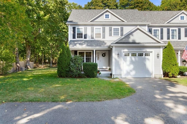 view of front of house featuring a garage and a front lawn