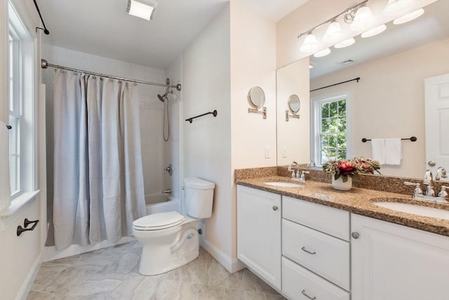 full bathroom with vanity, shower / bath combo with shower curtain, and toilet