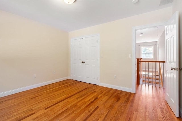 interior space with a closet and light hardwood / wood-style flooring