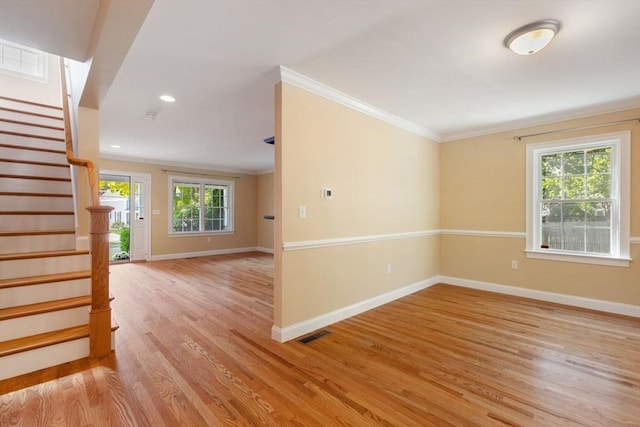 spare room with crown molding and light hardwood / wood-style floors