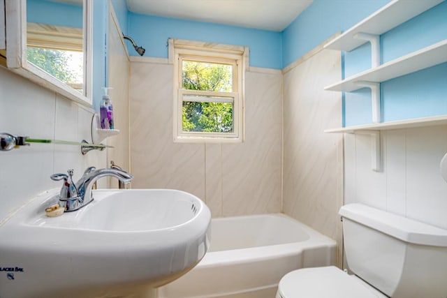 full bathroom featuring toilet, a sink, a tub to relax in, and a shower
