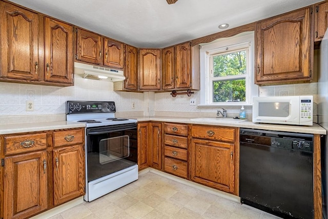 kitchen with range with electric cooktop, dishwasher, under cabinet range hood, white microwave, and brown cabinets
