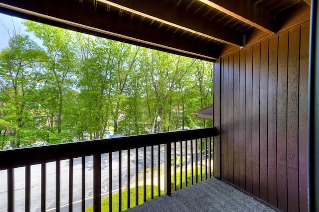 wooden deck featuring view of wooded area