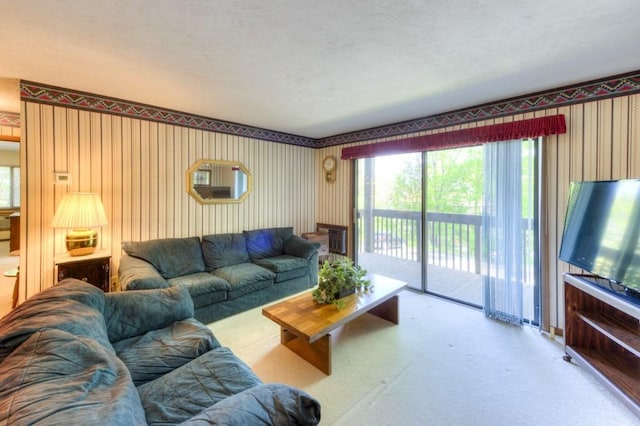 carpeted living room featuring wallpapered walls