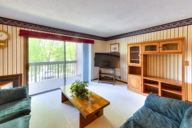 living area with wallpapered walls and carpet