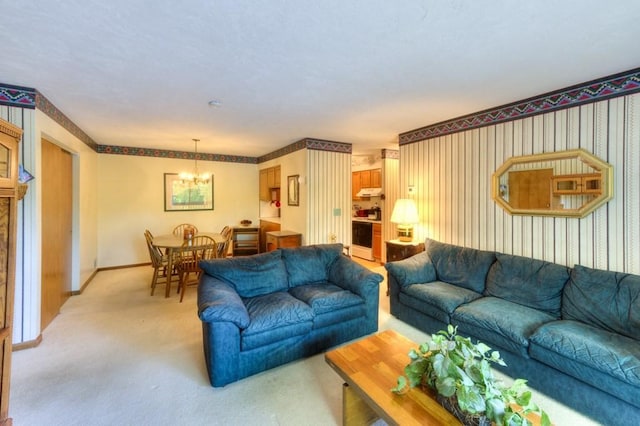living room featuring a chandelier, light colored carpet, and baseboards