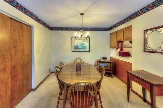 dining space featuring light colored carpet and a chandelier