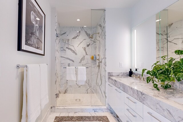 bathroom with vanity and a shower with shower door