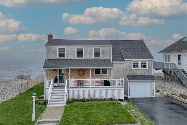 view of front of property featuring a porch, a water view, roof with shingles, and stairs