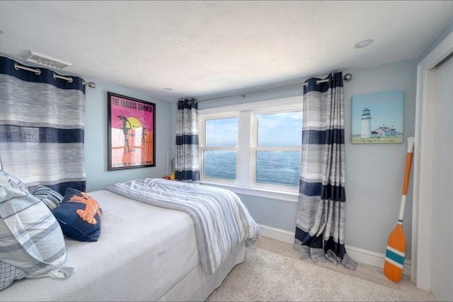 carpeted bedroom with baseboards and visible vents