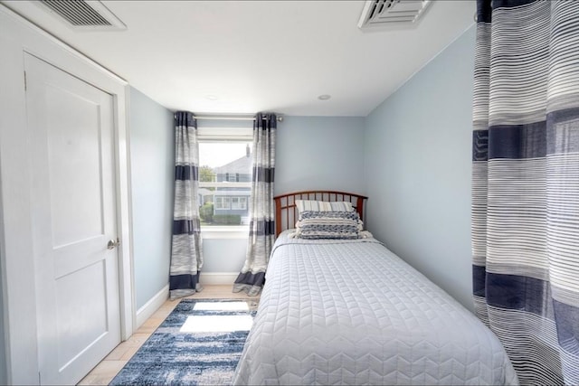bedroom with visible vents and baseboards