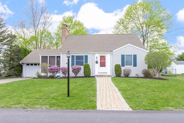 view of front facade featuring an attached garage, a front lawn, driveway, and a chimney