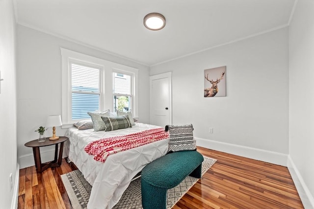 bedroom featuring hardwood / wood-style flooring and ornamental molding