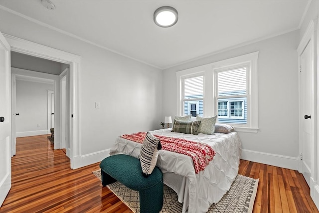 bedroom with crown molding and hardwood / wood-style flooring