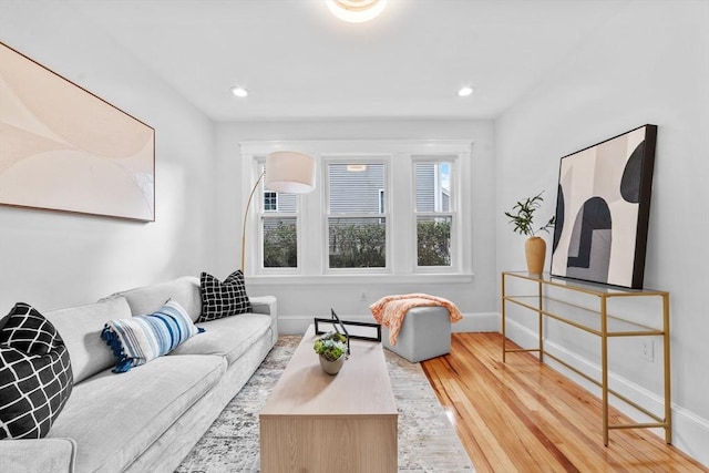 living room featuring a baseboard heating unit and hardwood / wood-style floors