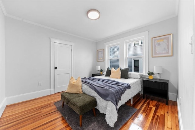 bedroom with wood-type flooring and ornamental molding