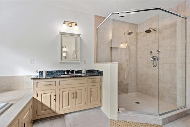 full bathroom with tile patterned flooring, a shower stall, and vanity