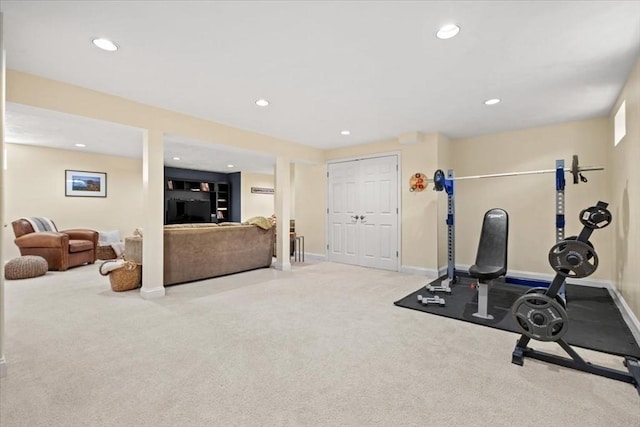 exercise room with recessed lighting, light carpet, and baseboards