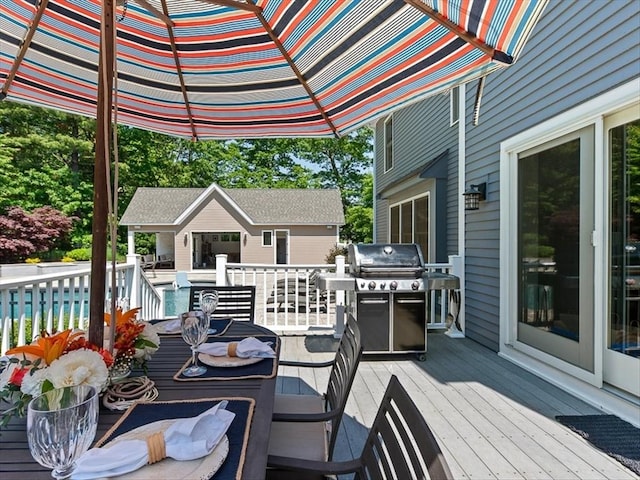 wooden terrace featuring a grill