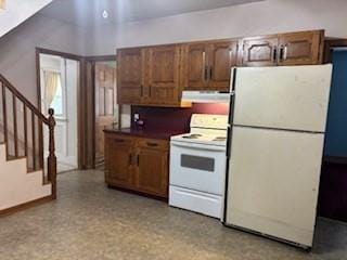 1774 Carew St, Springfield, MA 01104 - kitchen with white appliances, under cabinet range hood, and dark countertops