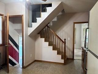 1774 Carew St, Springfield, MA 01104 - stairway with plenty of natural light and baseboards