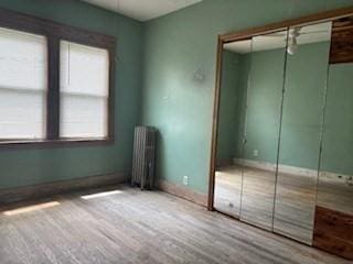 1774 Carew St, Springfield, MA 01104 - unfurnished bedroom featuring radiator, a closet, and baseboards