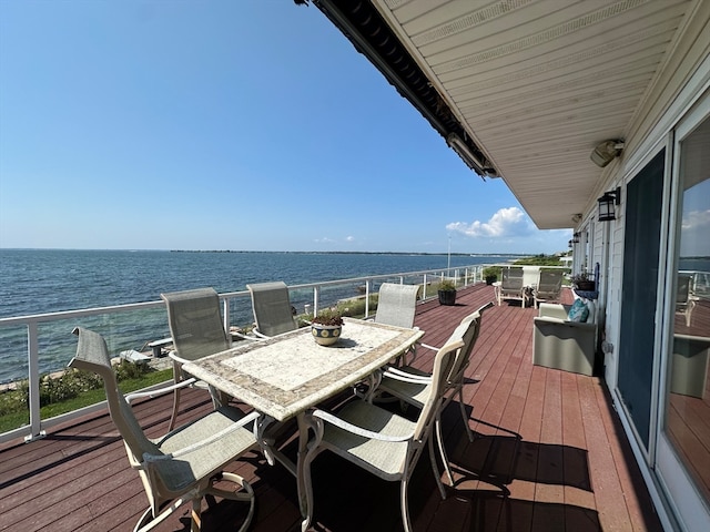 wooden terrace featuring a water view