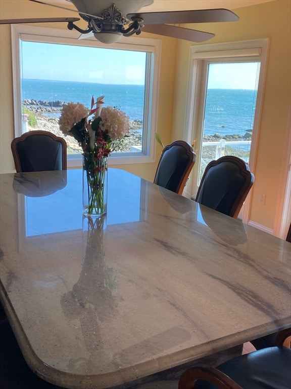 dining space featuring a water view