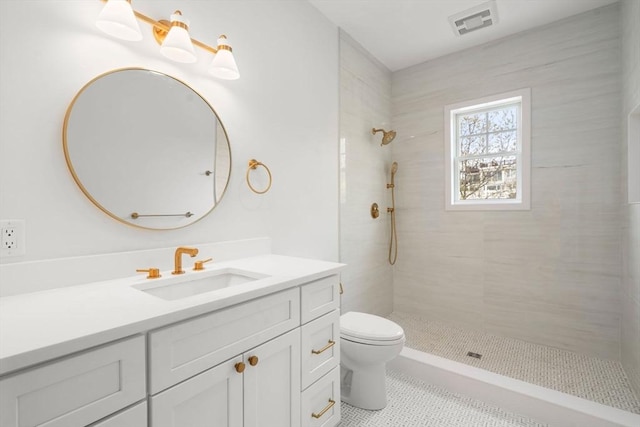 220 Atlantic St, Gloucester, MA 01930 - bathroom featuring tiled shower, toilet, vanity, and tile patterned floors