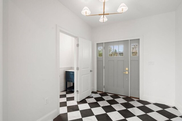 220 Atlantic St, Gloucester, MA 01930 - entryway with dark floors, a chandelier, and baseboards