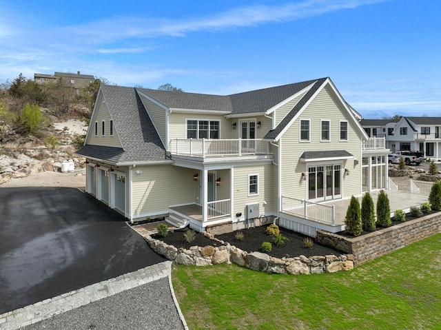 220 Atlantic St, Gloucester, MA 01930 - view of front of property featuring a balcony, asphalt driveway, a shingled roof, and an attached garage