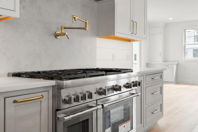 220 Atlantic St, Gloucester, MA 01930 - kitchen with double oven range, light countertops, and light wood-type flooring
