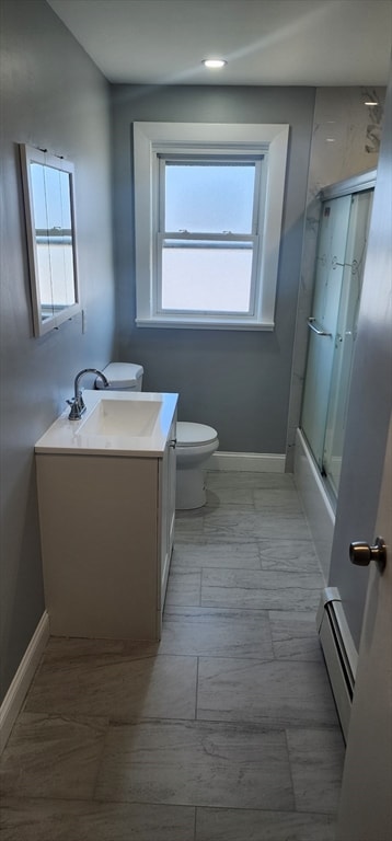 full bathroom with plenty of natural light, toilet, vanity, and a baseboard radiator