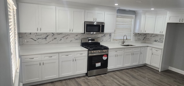 kitchen with white cabinets, dark hardwood / wood-style flooring, stainless steel appliances, and sink