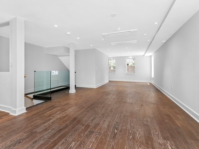 unfurnished living room featuring dark hardwood / wood-style flooring