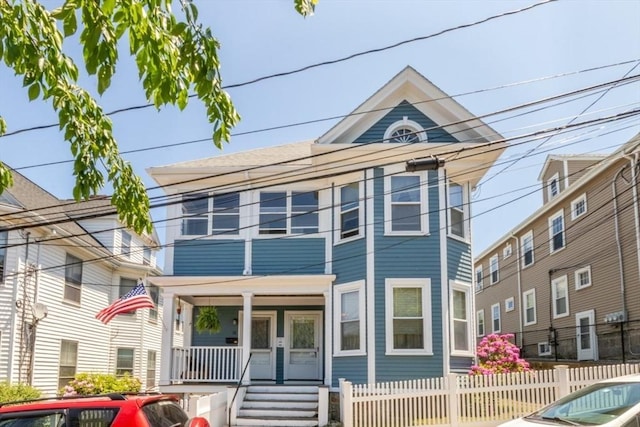 18 Dighton St Unit 18, Boston, MA 02135 - view of front facade featuring covered porch and a fenced front yard