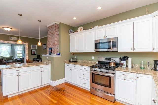 18 Dighton St Unit 18, Boston, MA 02135 - kitchen with appliances with stainless steel finishes, white cabinets, a peninsula, light wood-style floors, and decorative light fixtures